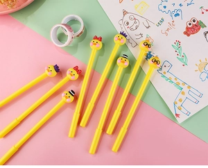 Detailed view of yellow cartoon duck gel pens with cute bow and hat top decorations