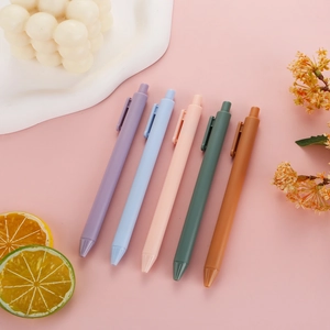 Five Morandi macaron gel pens in soft colors with minimalist matte finish set on pink