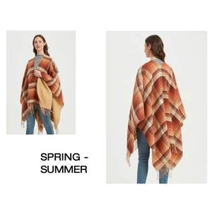 Detail view of Scottish plaid shawl cape with tassels in orange and brown tones