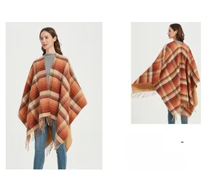 Detail of plaid poncho wrap with fringes in autumn tones and split design