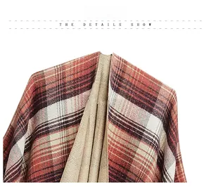 Detail view of thick knit acrylic shawl showing orange plaid pattern and texture