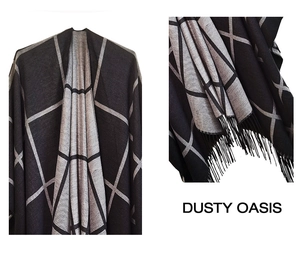 Detail of grey plaid pattern and tassel fringe on women's double-sided poncho
