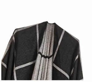 Detail view of thickened knit shawl showing grey and black geometric pattern texture