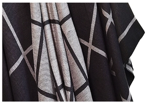 Detail shot of soft black and grey plaid knit fabric with large crisscross grid patterns