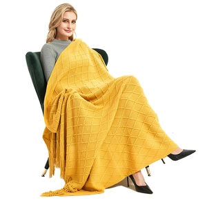 Bright yellow diamond knit throw blanket with fringe tassels for sofa or bed decor