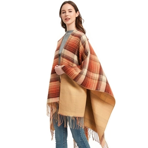 Women's plaid poncho with fringe details in autumn orange and brown tones