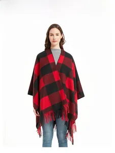 Close-up of red and black buffalo plaid poncho wrap showing thick texture and long tassels