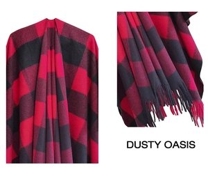 Detail of red and black plaid shawl featuring thick knit texture and long fringe tassels