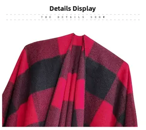 Detailed view of thick red and black plaid pattern fabric with fringe on a winter shawl