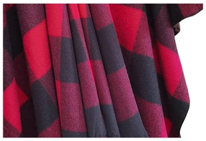 Close-up of red and black buffalo check pattern on thick fringed wrap shawl