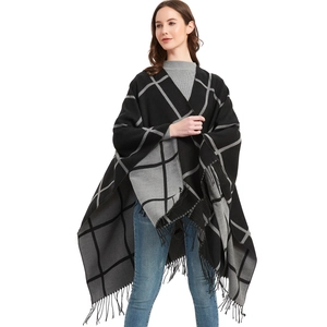 Women's black and grey plaid tassel poncho wrap with elegant fringe details for autumn