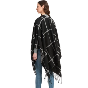 Women's black and grey plaid poncho with fringe trim and oversized check pattern