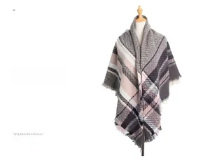 Detail of thick plaid scarf with grey pink and black checks featuring soft fringed edges