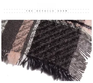 Detail shot of soft herringbone scarf featuring grey and pink patchwork with fringe edges
