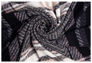 Macro detail of classic herringbone weave on a thick plaid shawl scarf with soft texture