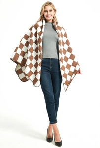 Detailed knit texture of a brown and white checkered shawl with fine stitched edges