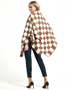Detail showing the brown and white checkered knit texture and fine overlock stitching