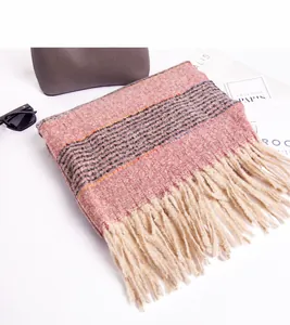 Macro detail of soft striped scarf with lilac pink tones and delicate fringe trim