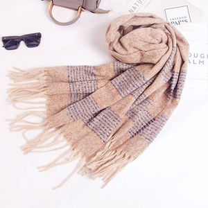 Soft striped beige knit scarf with orange blue checks and tassels on white background