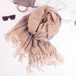 Soft striped beige scarf with tassels styled with fashion sunglasses and a magazine