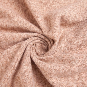 Detail of soft plush knitted fabric texture in mauve and brown with warm fuzzy finish