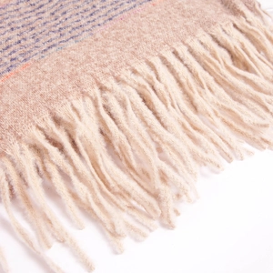 Close-up of soft striped knit scarf featuring warm beige tones and cream fringe tassels