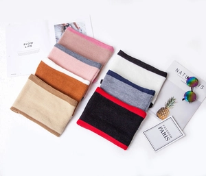 Detail of color-blocked knit scarves in seven vibrant color combinations for children