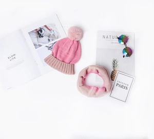 Detail of pink and beige patchwork knitted hat and neck warmer set for kids