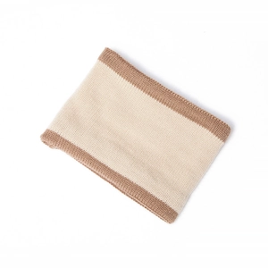 Detail of color-block knit neck warmer with ribbed texture in beige and camel tones