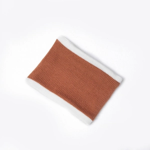 Detail of color-block knit neck warmer in caramel brown and beige with fine texture