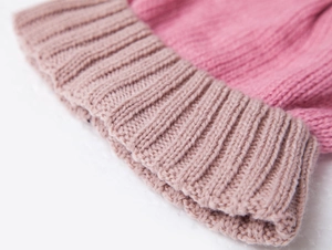 Close-up of pink color-block ribbed knit children's beanie showing soft fabric detail