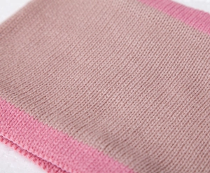 Close-up of color-block knit texture in pink and magenta for children winter set