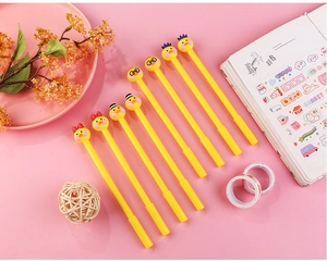 Flat lay of creative 0.5mm yellow cartoon duck pens with various head accessories