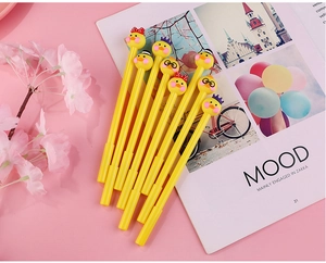Detailed view of yellow cartoon duck pens with various cute head decorations on pink background