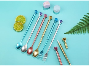 Creative diamond topped pens in fork and spoon shapes on a blue aesthetic background
