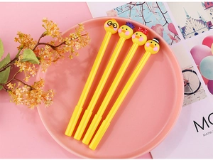 Detail of four cartoon yellow duck gel pens with cute character toppers on pink tray