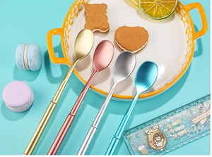 Close-up of four-color creative long handle stainless steel spoons in various metal finishes