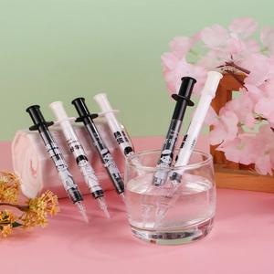 Creative syringe-shaped gel pens in black and white with cute cartoon character prints