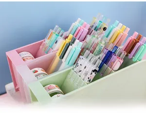 Detail view of multi-compartment slanted desk organizers in pastel pink, white and green