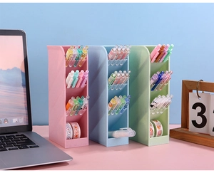 Detailed view of pink, blue and green slanted multi-compartment desk stationery organizers