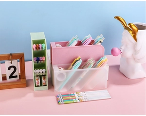 Macro detail of slanted pen holder compartments in frosted morandi green and pink plastic