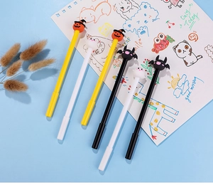Macro shot of Halloween gel pens with pumpkin and ghost toppers on a notebook