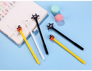 Close-up of five Halloween gel pens with pumpkin, bat and ghost silicone toppers on blue background