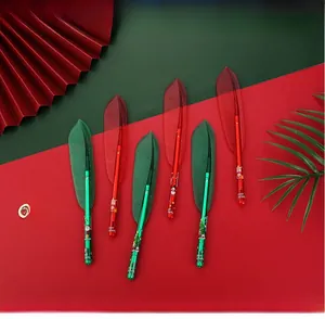 Detailed view of Christmas feather pens with red and green reindeer and Santa patterns