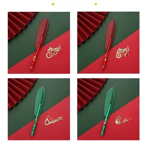 Close-up of Christmas feather pens in red and green with festive holiday patterns