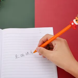 Close-up of orange Christmas reindeer sock gel pen writing on a white lined notebook