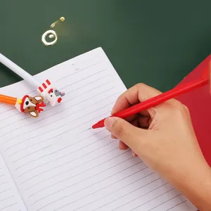 Detailed shot of Christmas gel pens being used for writing on festive themed stationery