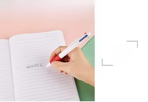 Detail of 0.7mm 4-in-1 multi-color ballpoint pen writing smoothly on a notebook