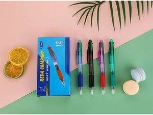 Detail of 0.7mm four-color retractable ballpoint pens with soft rubber grips in a storage box
