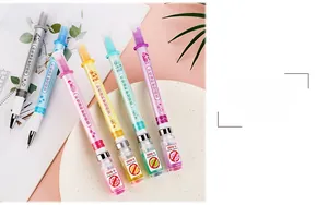Detail of creative syringe shaped pens with mini vaccine bottle charms on pink background
